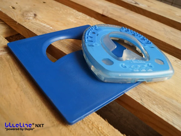 Il blueline® NXT è appoggiato sul Sole Relief Pad, anch’esso blu e di forma quadrata. Nella parte superiore, il pad presenta un’apertura a forma di mezzaluna.
