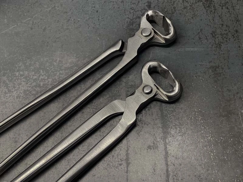Deux modèles de pinces à parer GE posés côte à côte sur une surface métallique.
